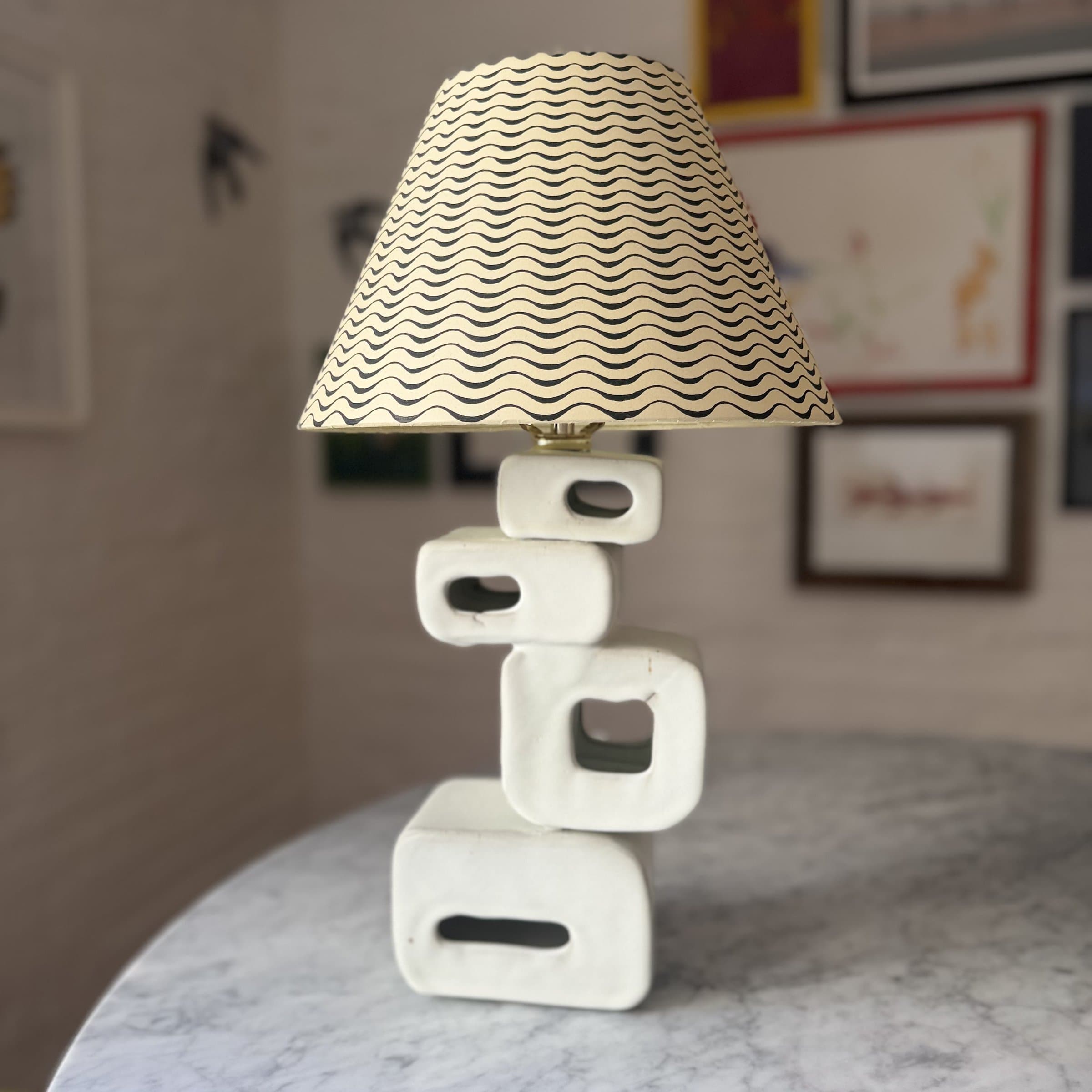 The biggest ceramic lamp, a hand-built base with a linen shade — the first lamp the studio ever made.