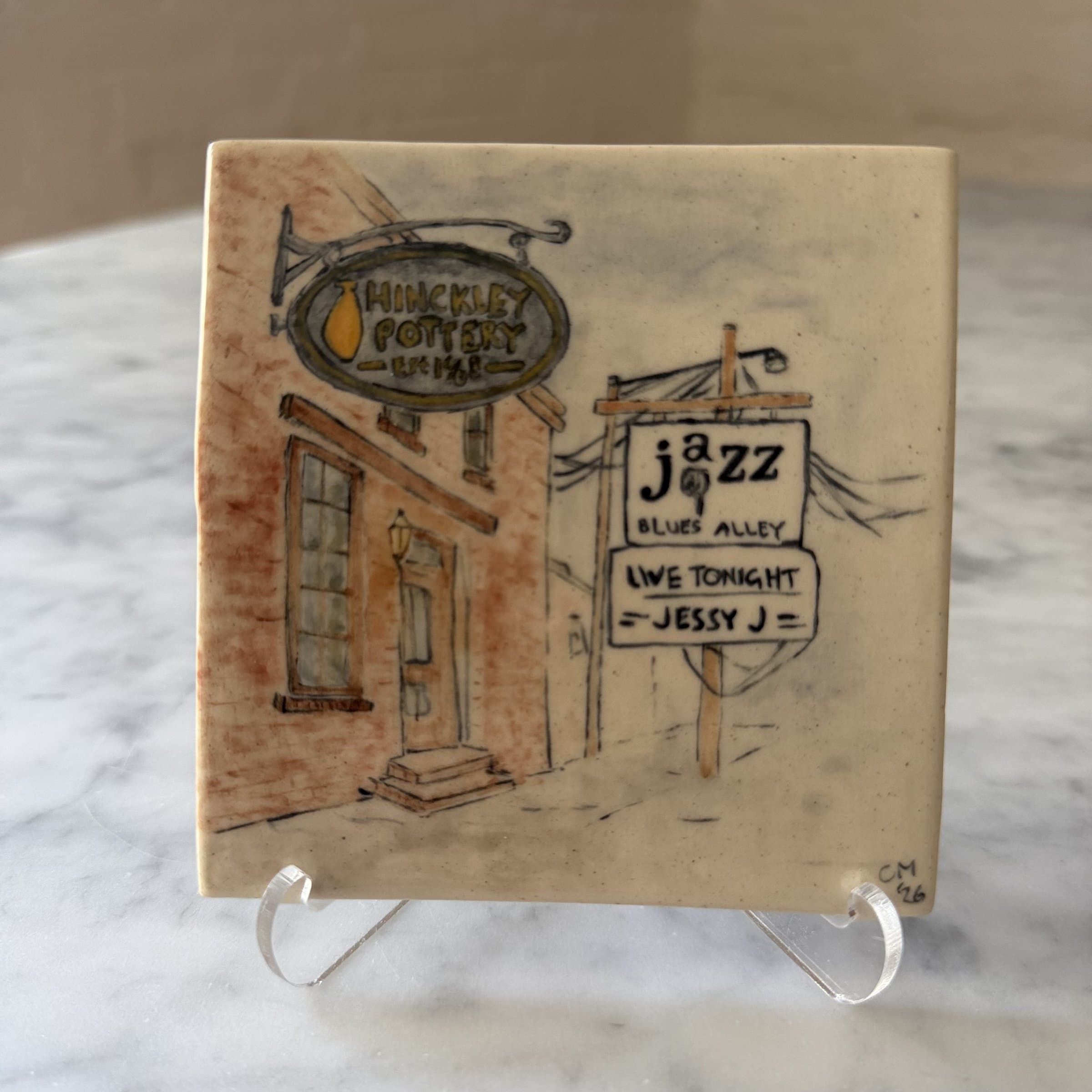 A hand-painted tile of a DC street corner with a sign reading Jazz — Blues Alley.